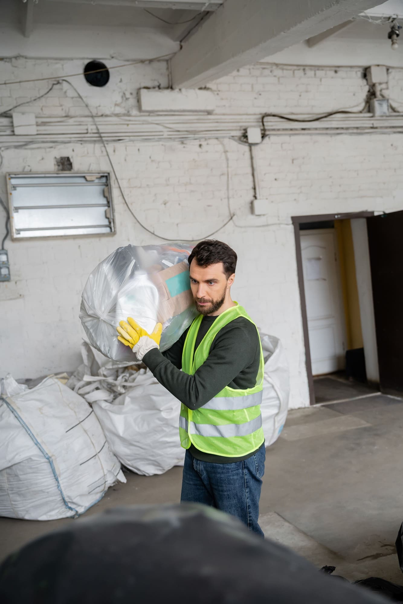 bearded-worker-in-protective-vest-and-gloves-carry-2023-11-27-04-59-33-utc (1) (2) (1)