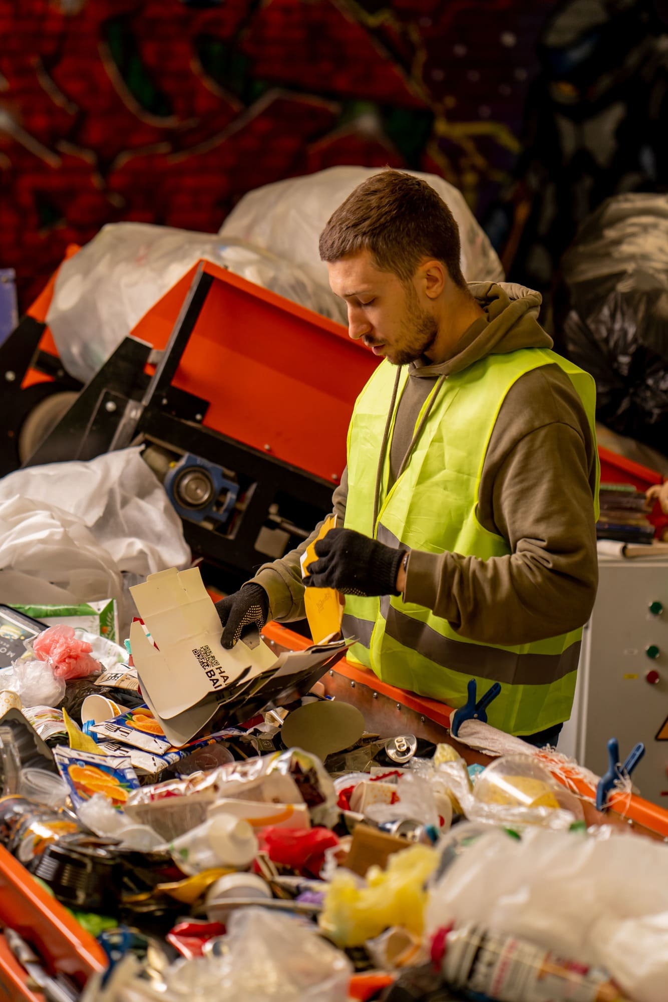 sorter-in-gloves-and-a-protective-vest-who-sorts-g-2024-01-26-17-04-53-utc (1) (1) (1)